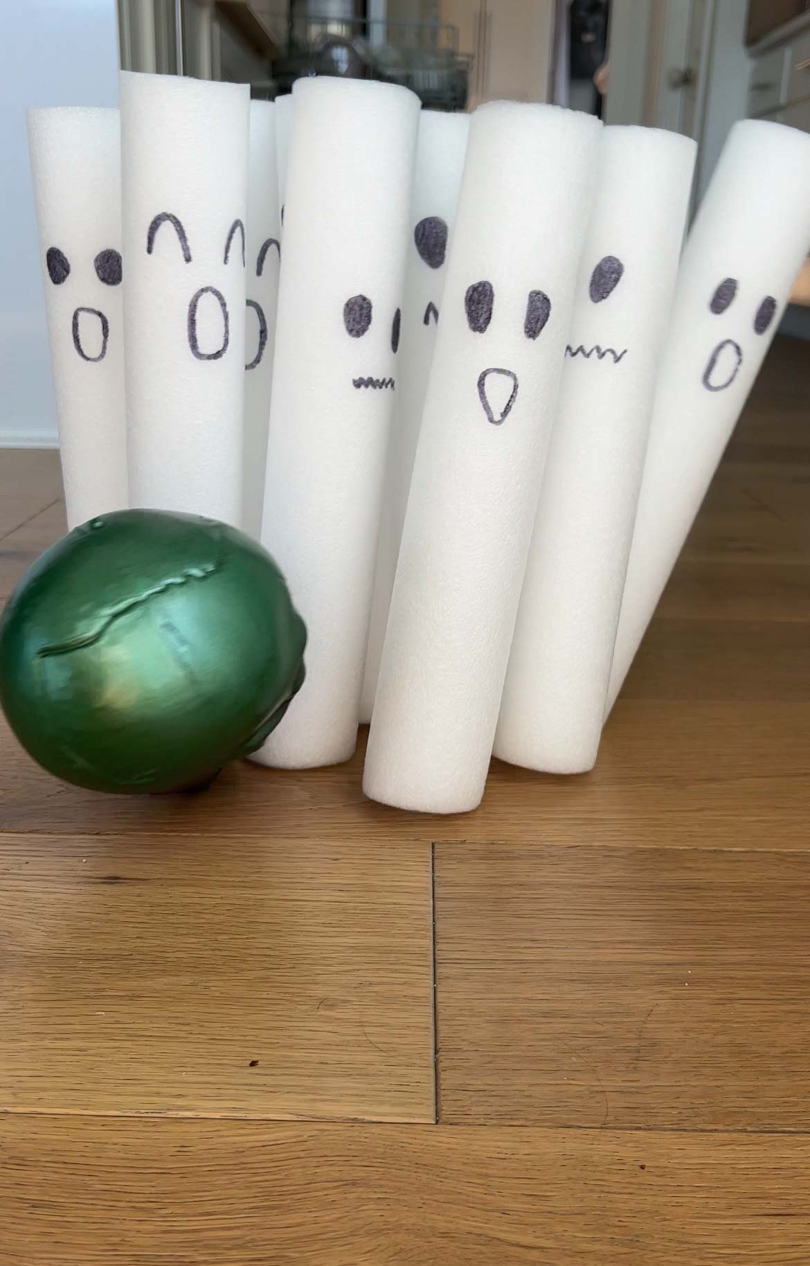 plastic skull rolling into ghost bowling pins