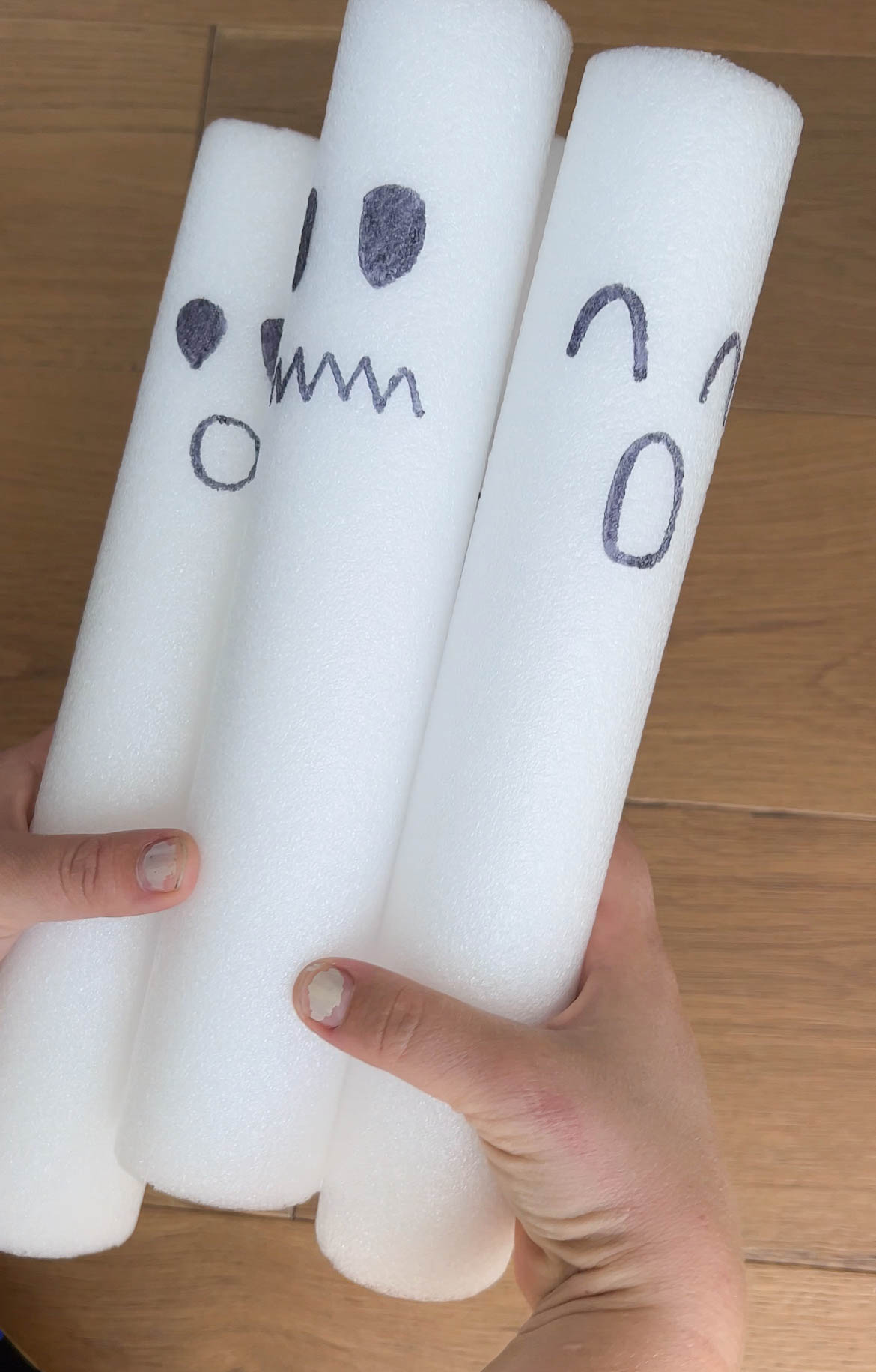 three pieces of white pool noodle with faces