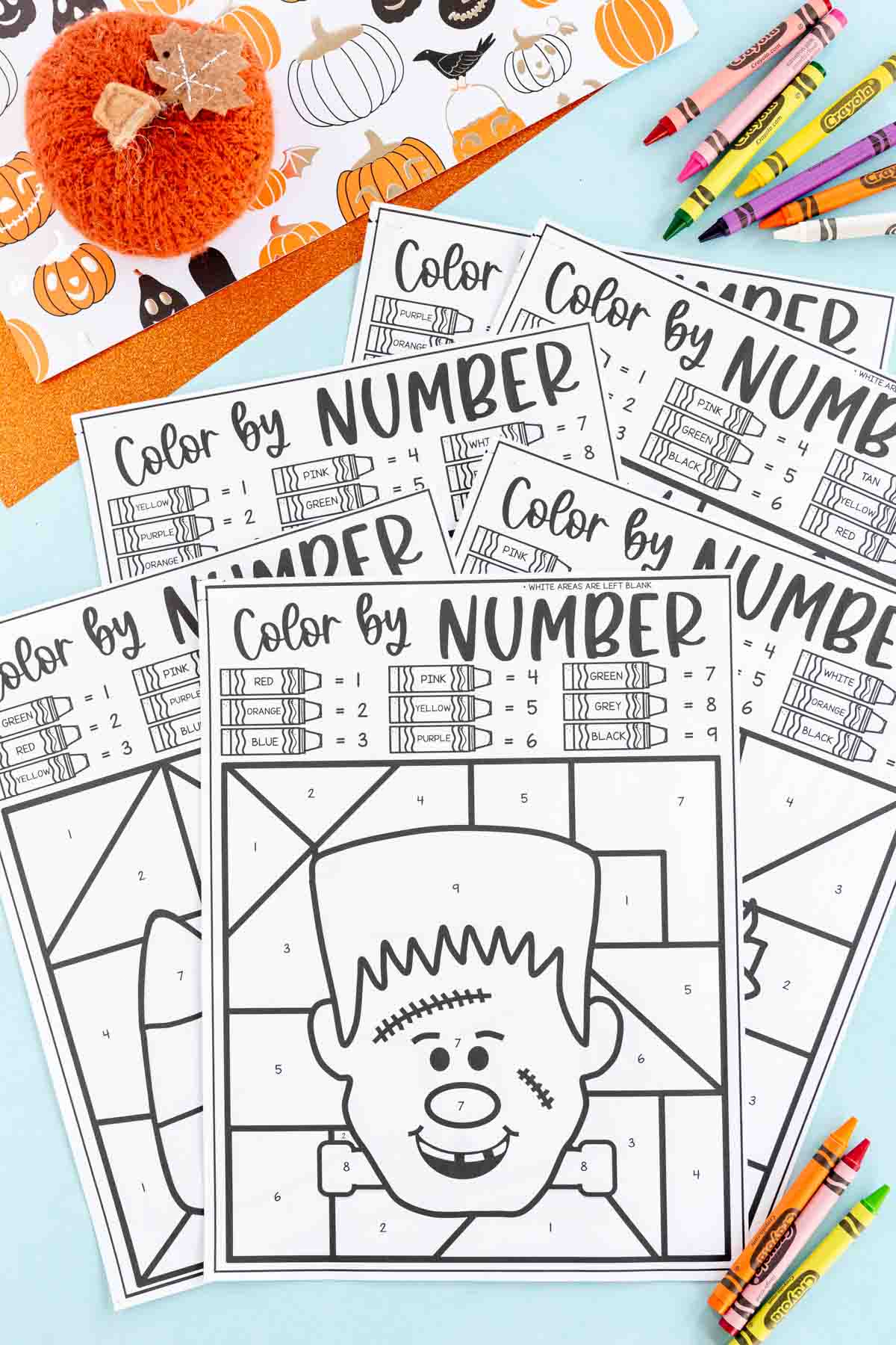 Halloween color by number pages stacked on top of each other
