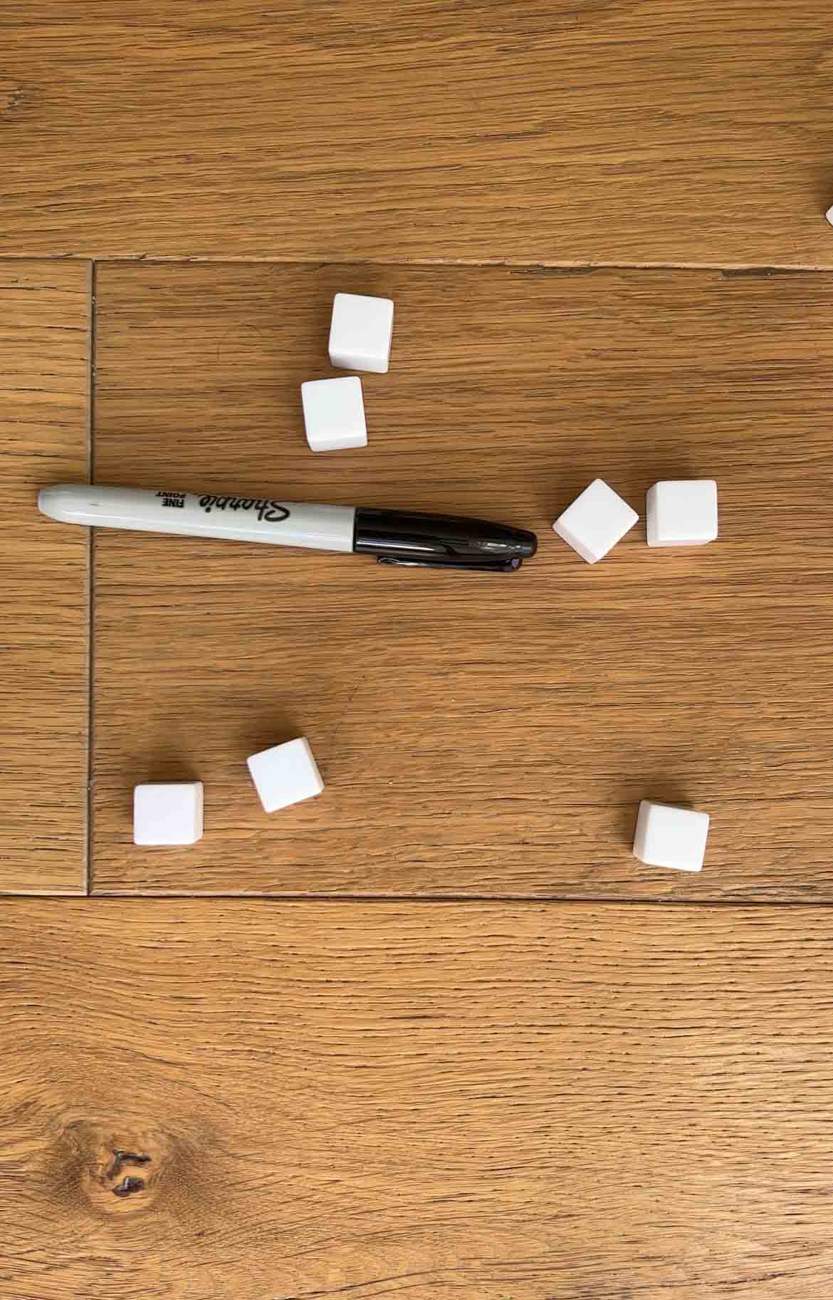 blank dice with a black Sharpie