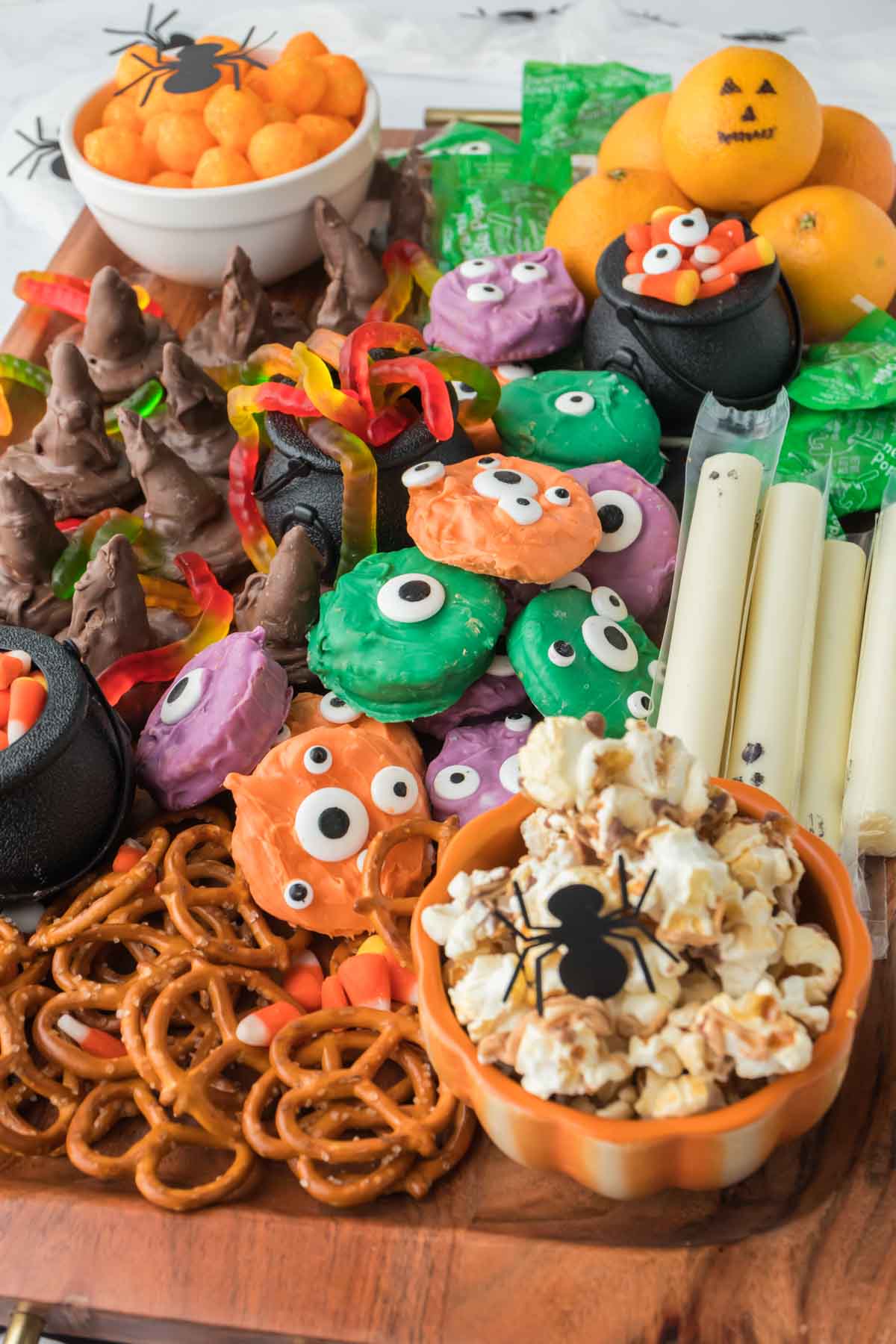 Halloween snack board with spiders on the caramel corn