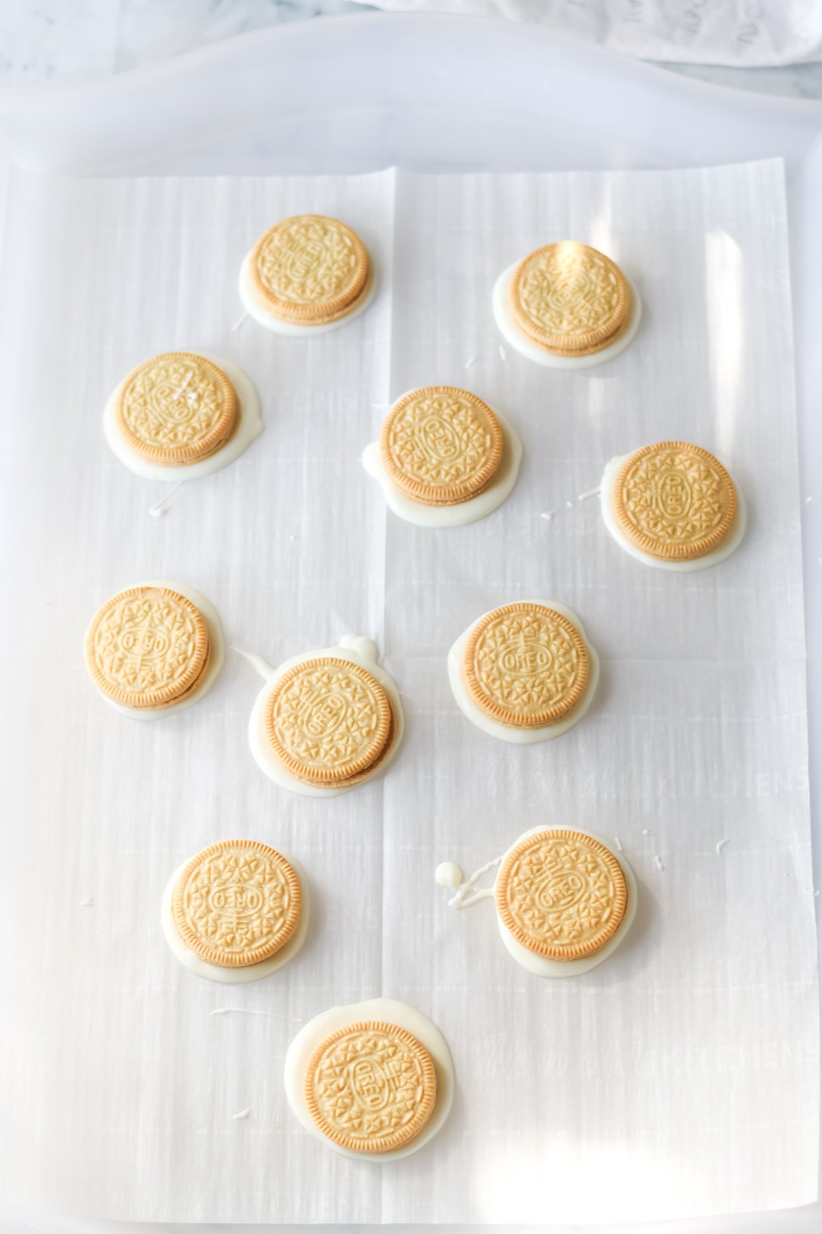golden Oreos on a piece of parchment paper