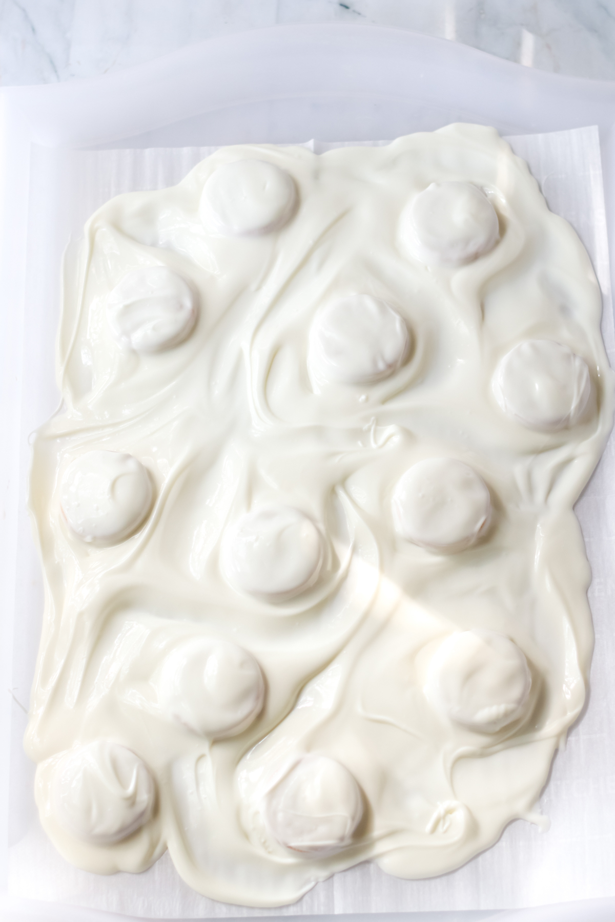 melted white chocolate on a baking sheet