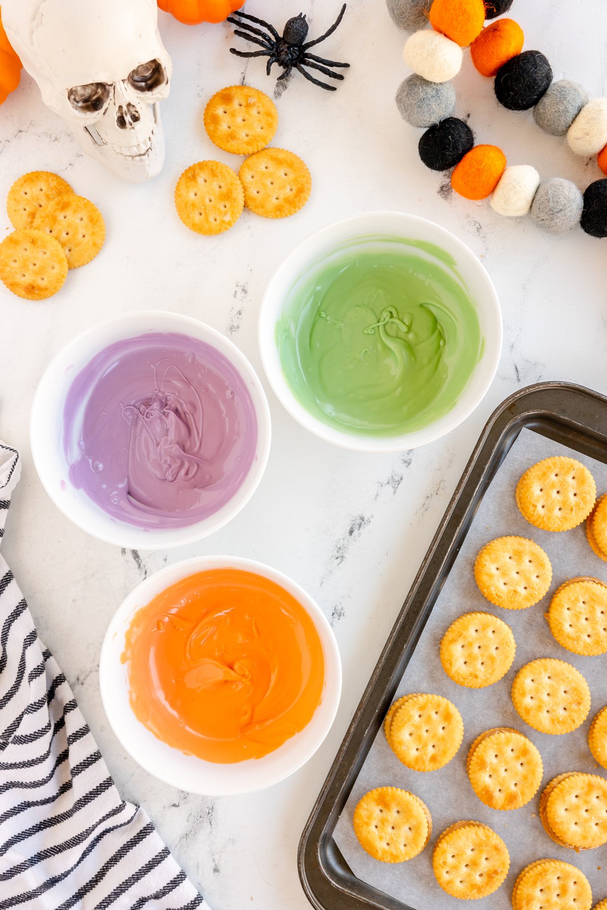 three colors of melted candy melts in white bowl