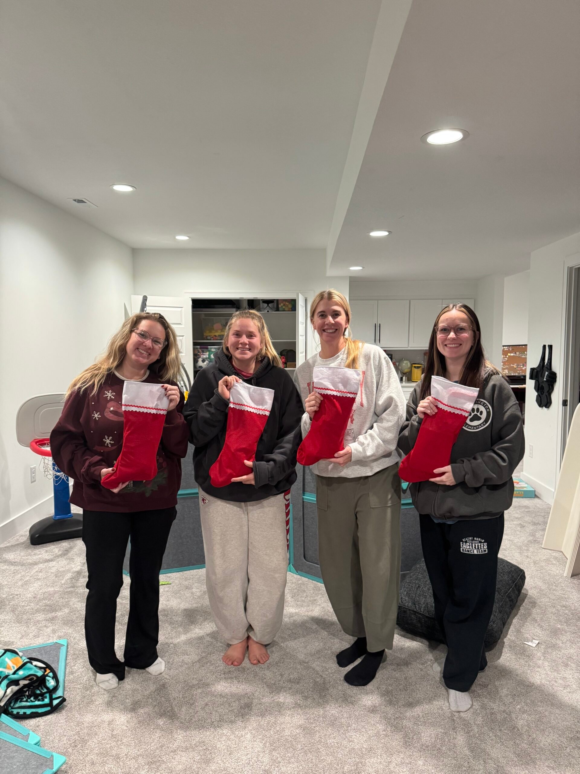 four women holding stockings