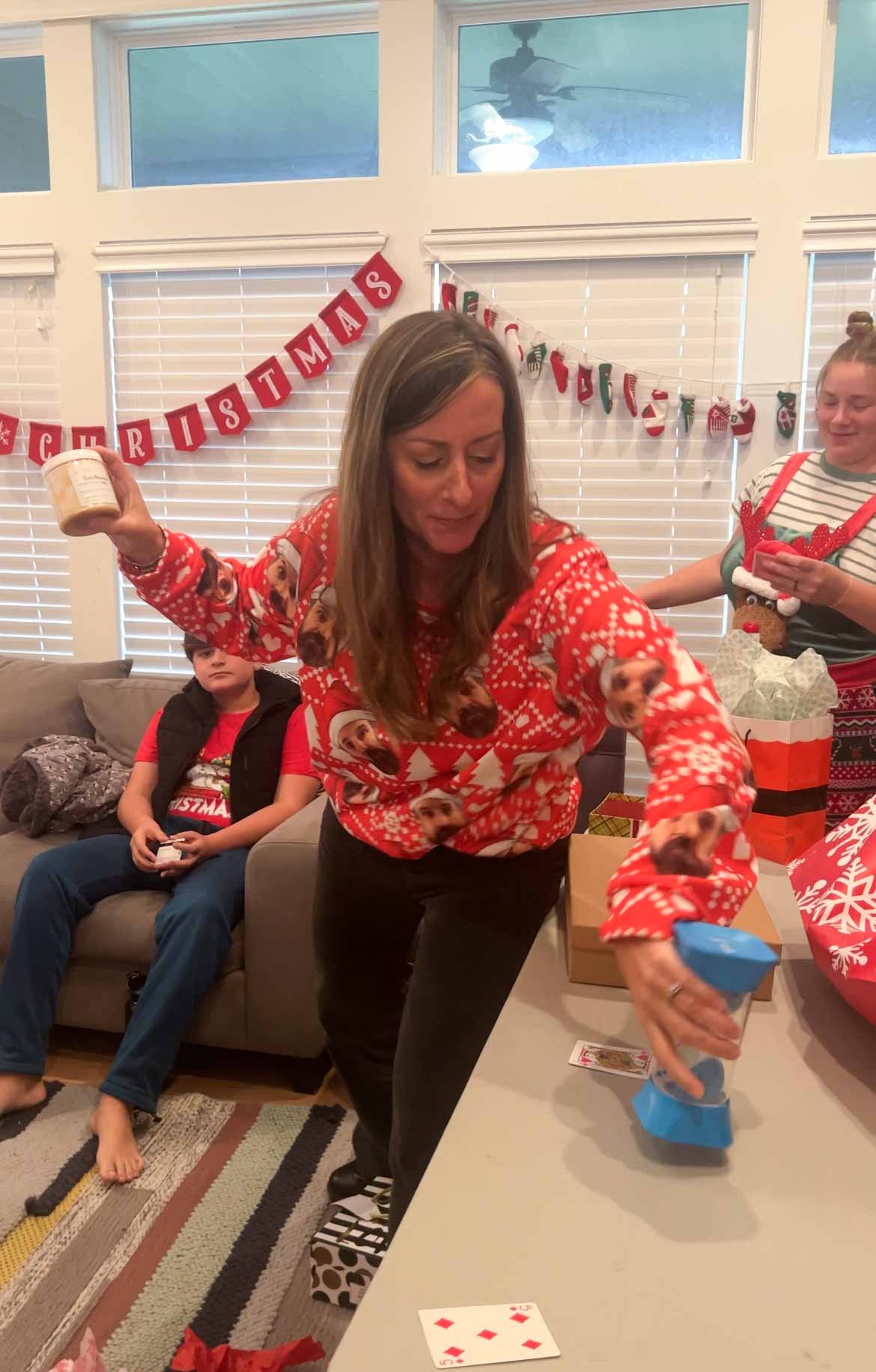 woman showing her gift to people playing a gift exchange game