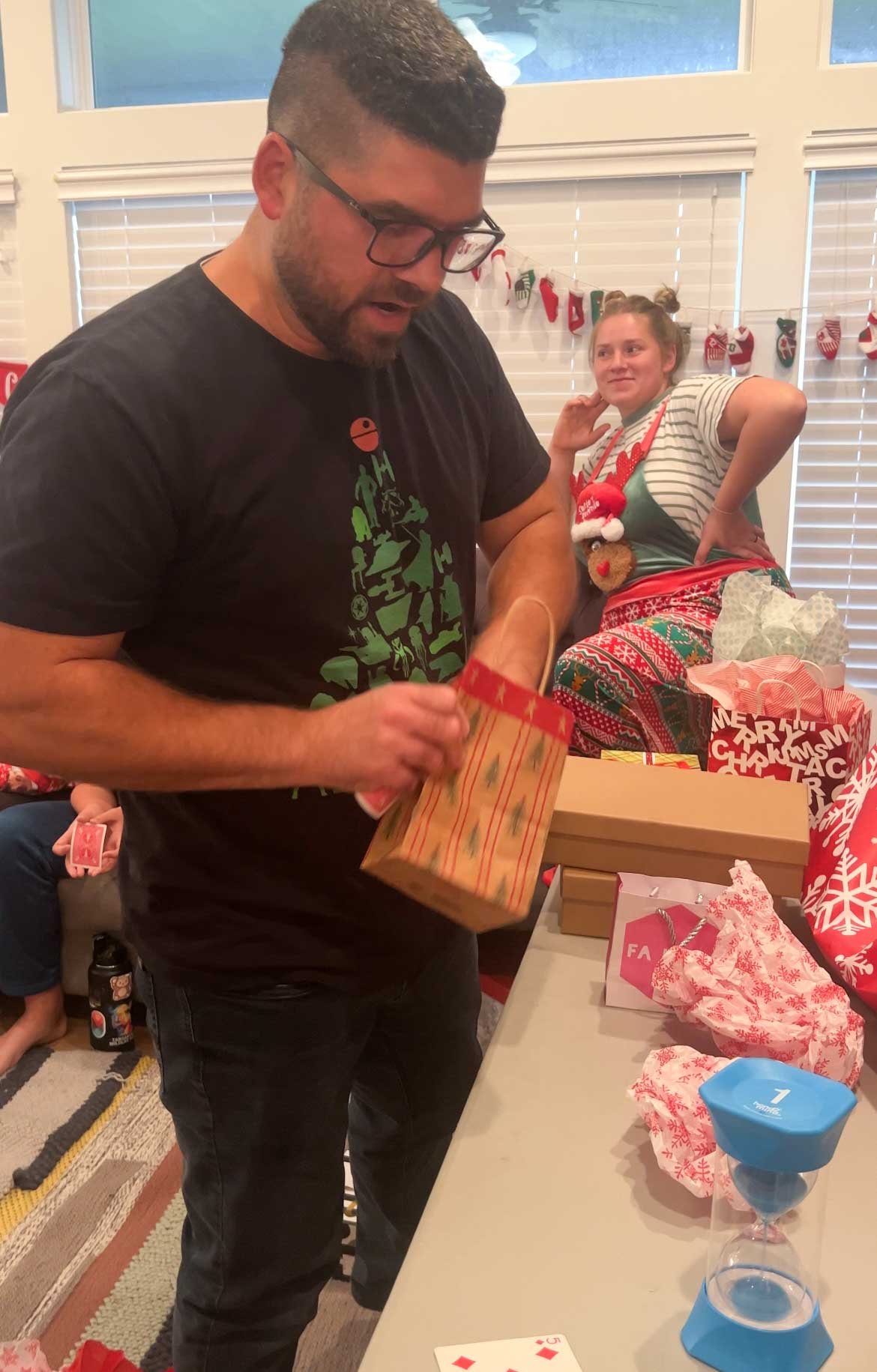 man opening a gift bag