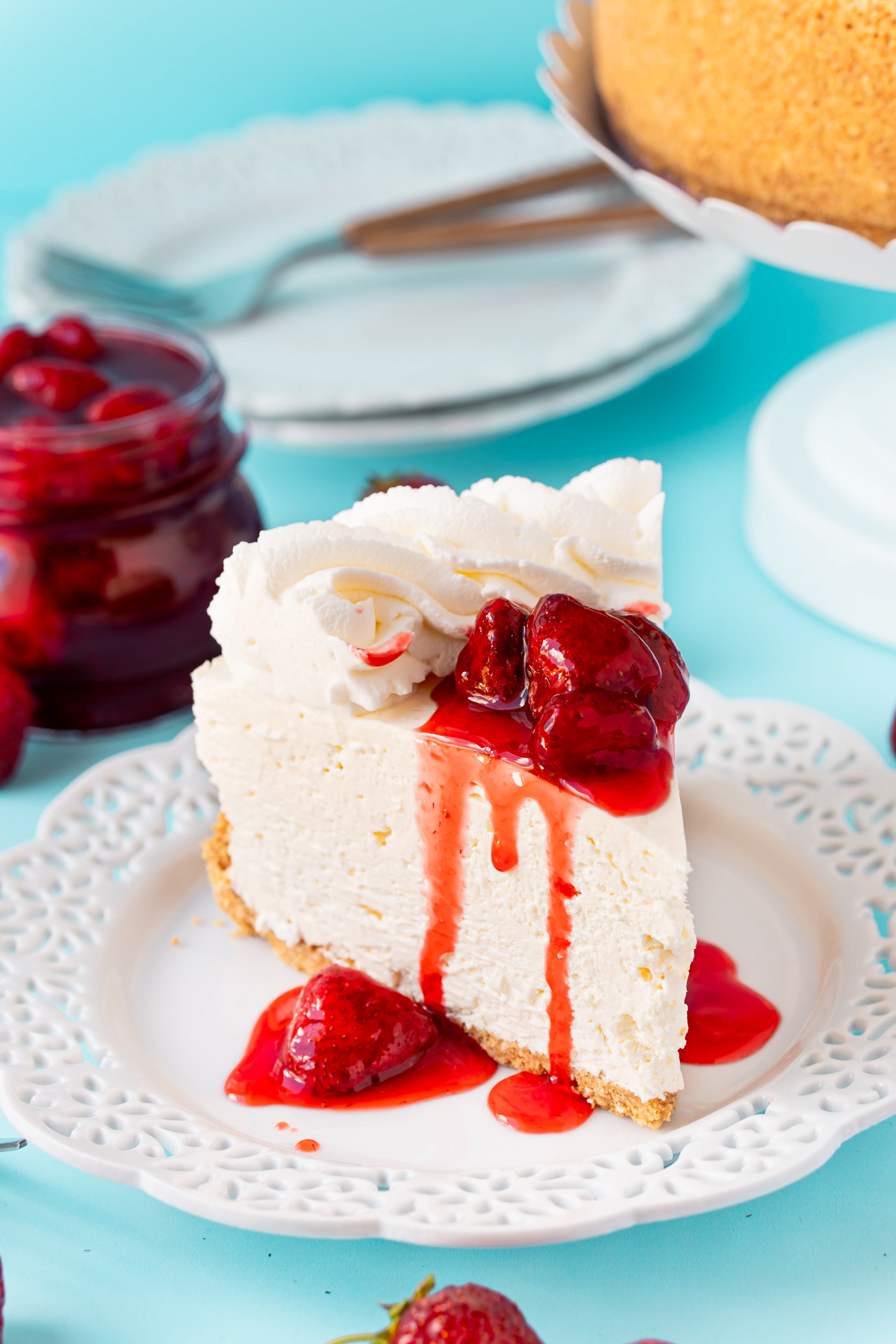slice of no bake cheesecake with strawberry sauce on top