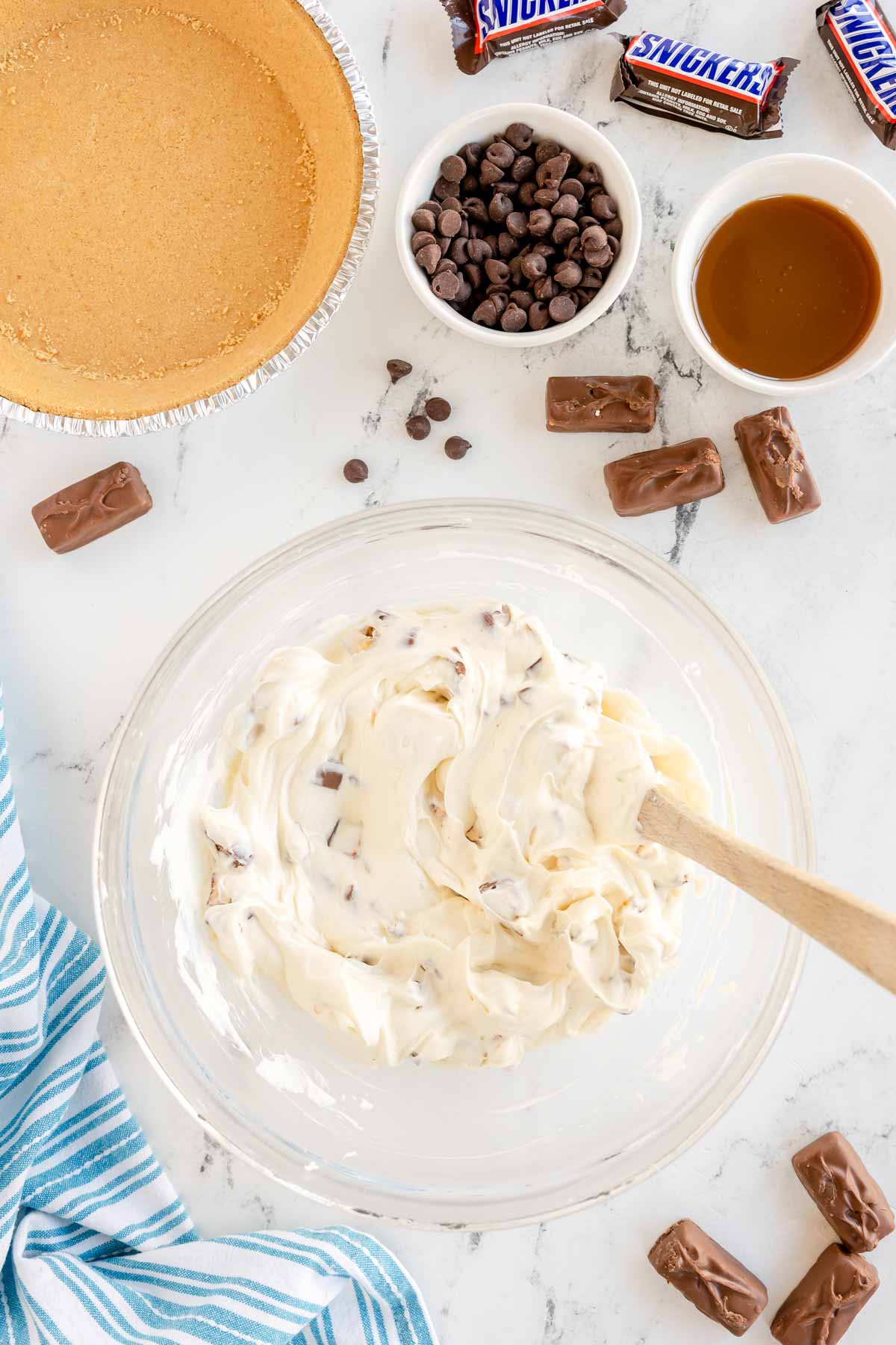 Fold in about 1 1/2 cups chopped Snickers using a spatula