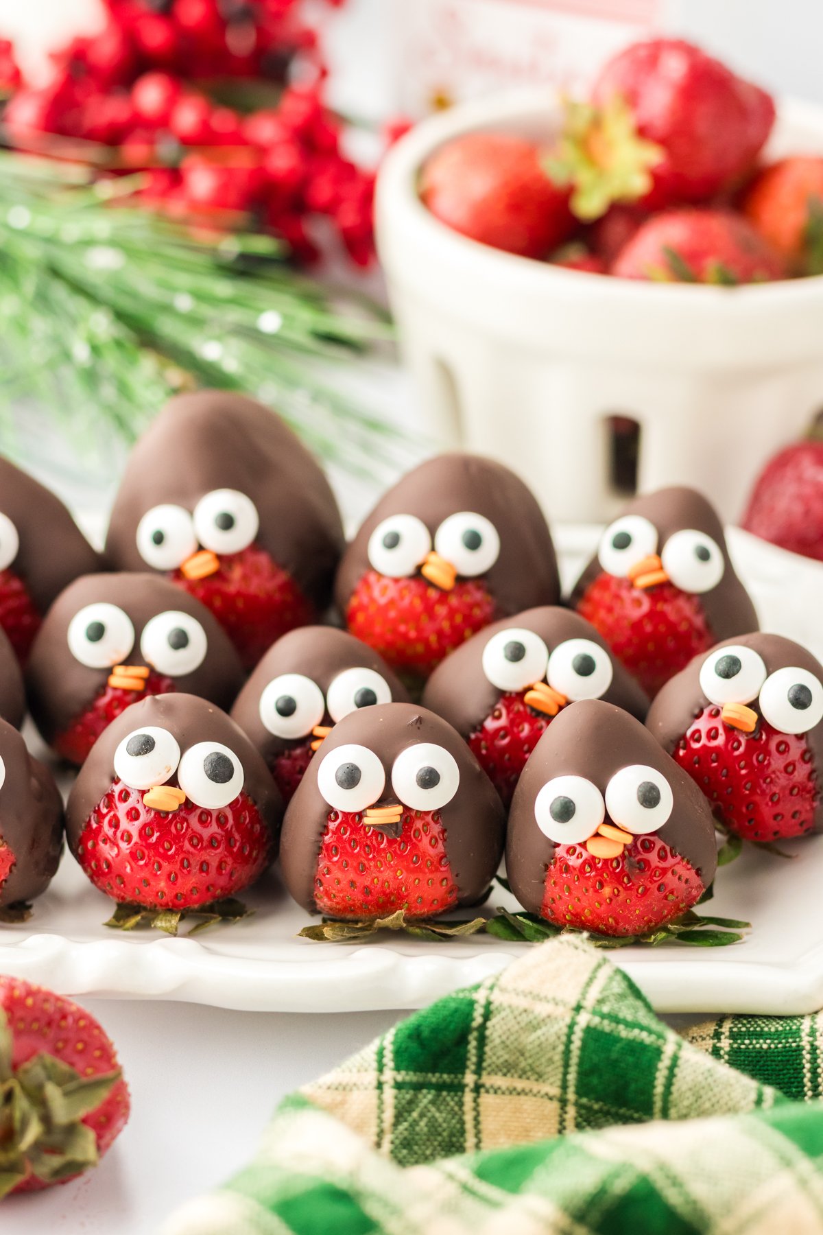 white plate full of chocolate covered strawberry penguins