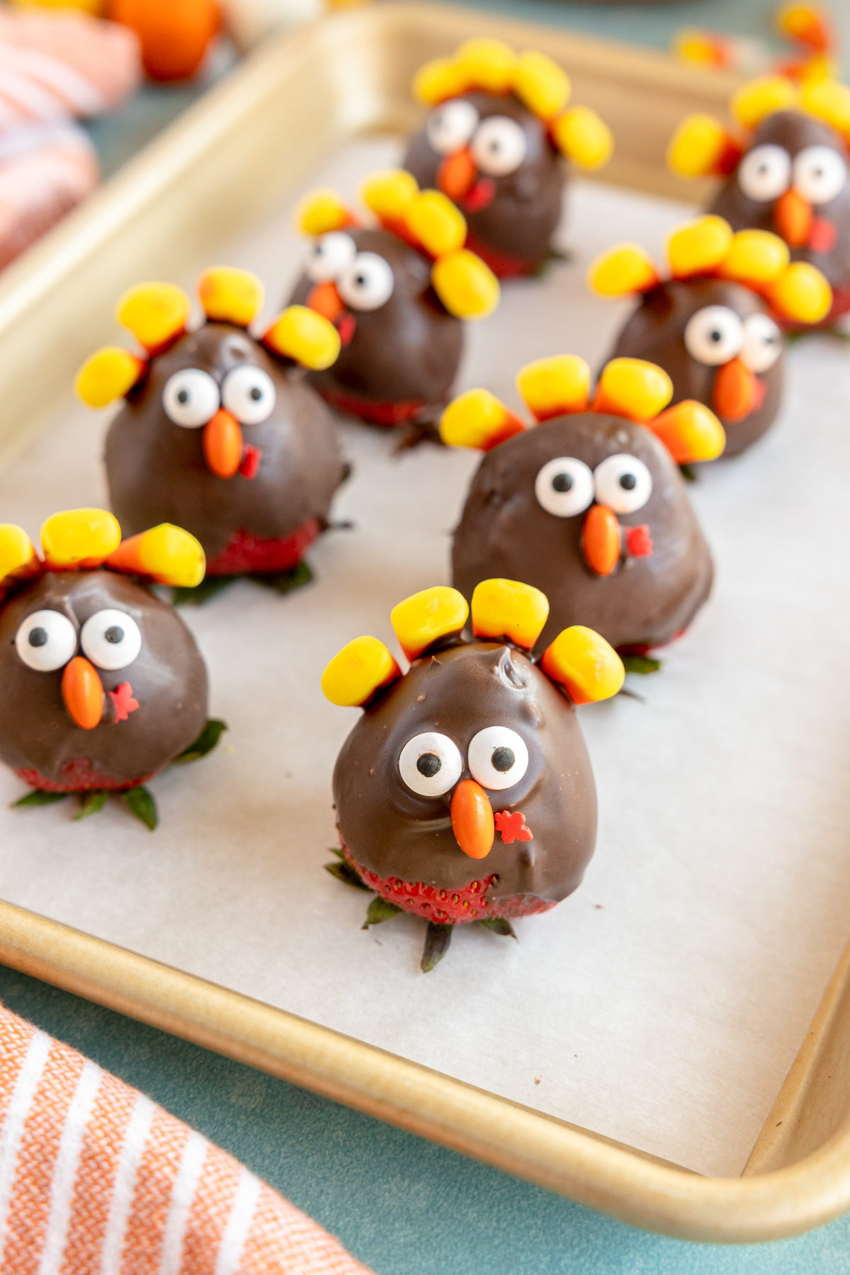 chocolate covered strawberry turkeys on a piece of parchment paper