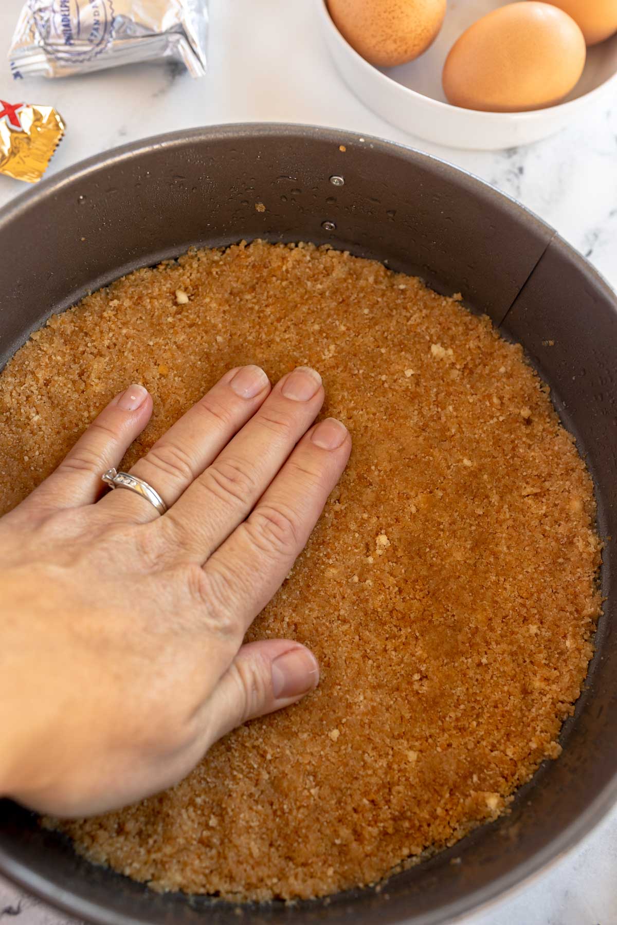 pressing a crust into a springform pan