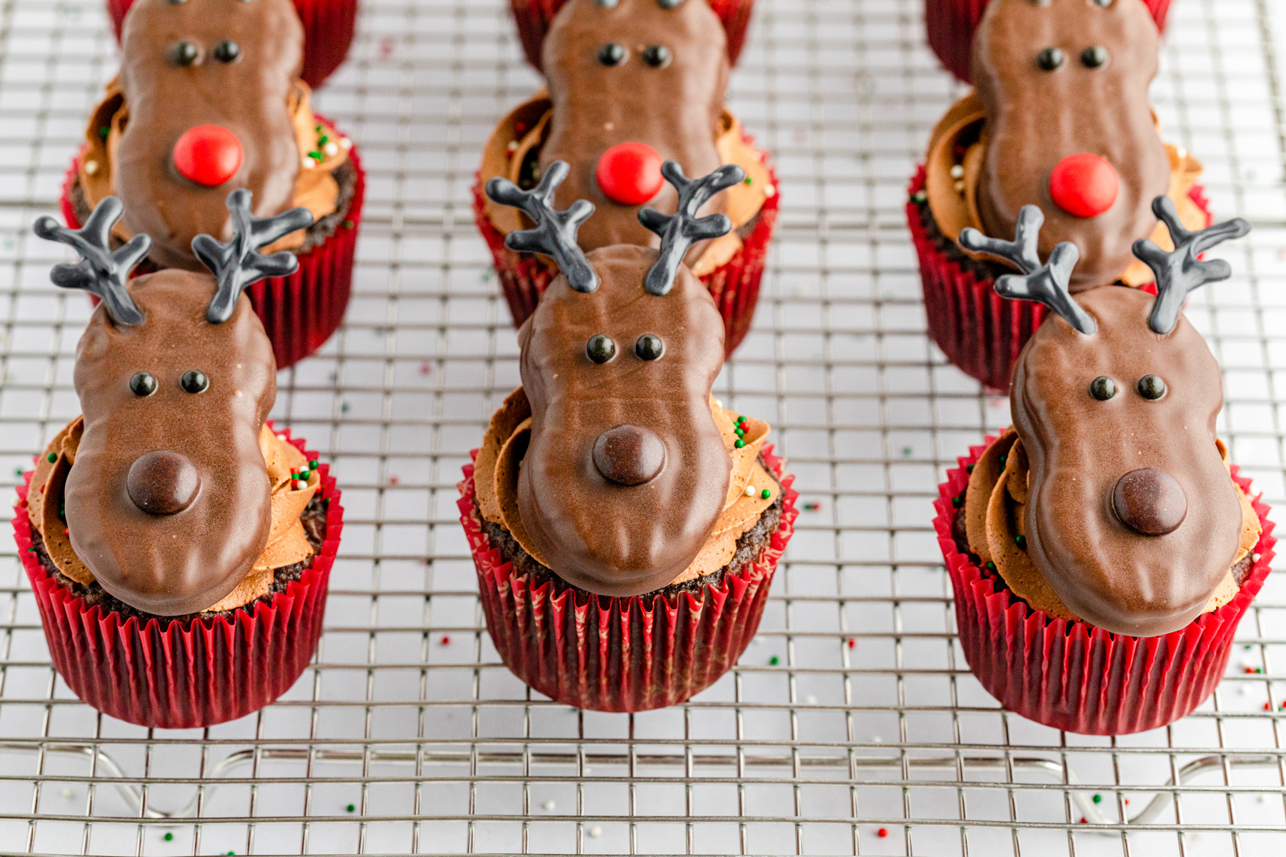 cooling rack with a bunch of reindeer cupcakes