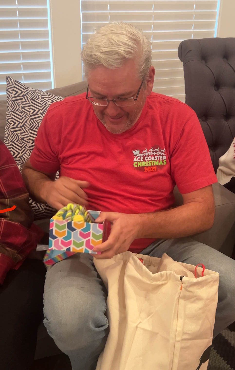 A grandpa opening a gift box 