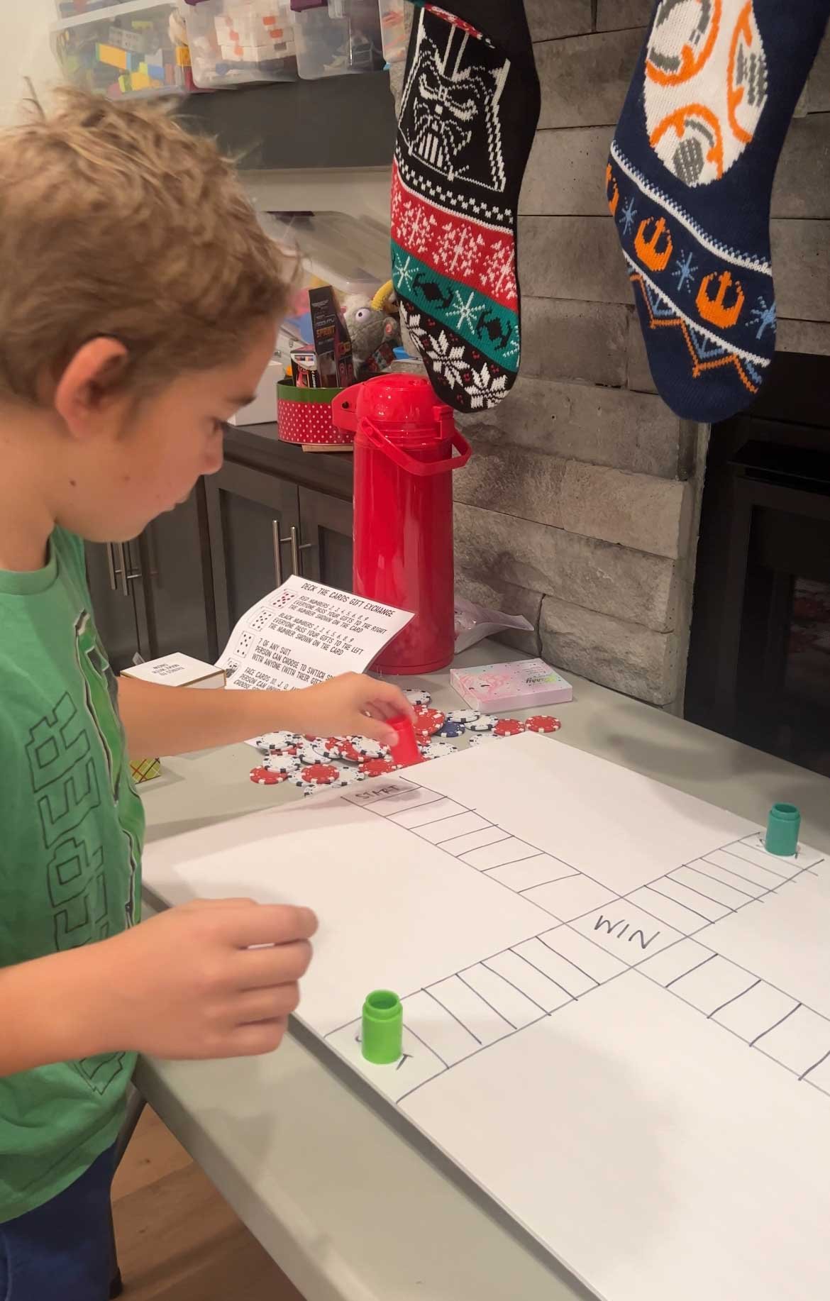 kid moving a playing piece of a game board