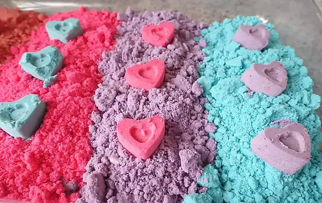 variety of colored baking soda with heart shapes