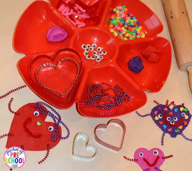 dip tray with various playdough supplies to make playdough heart monsters