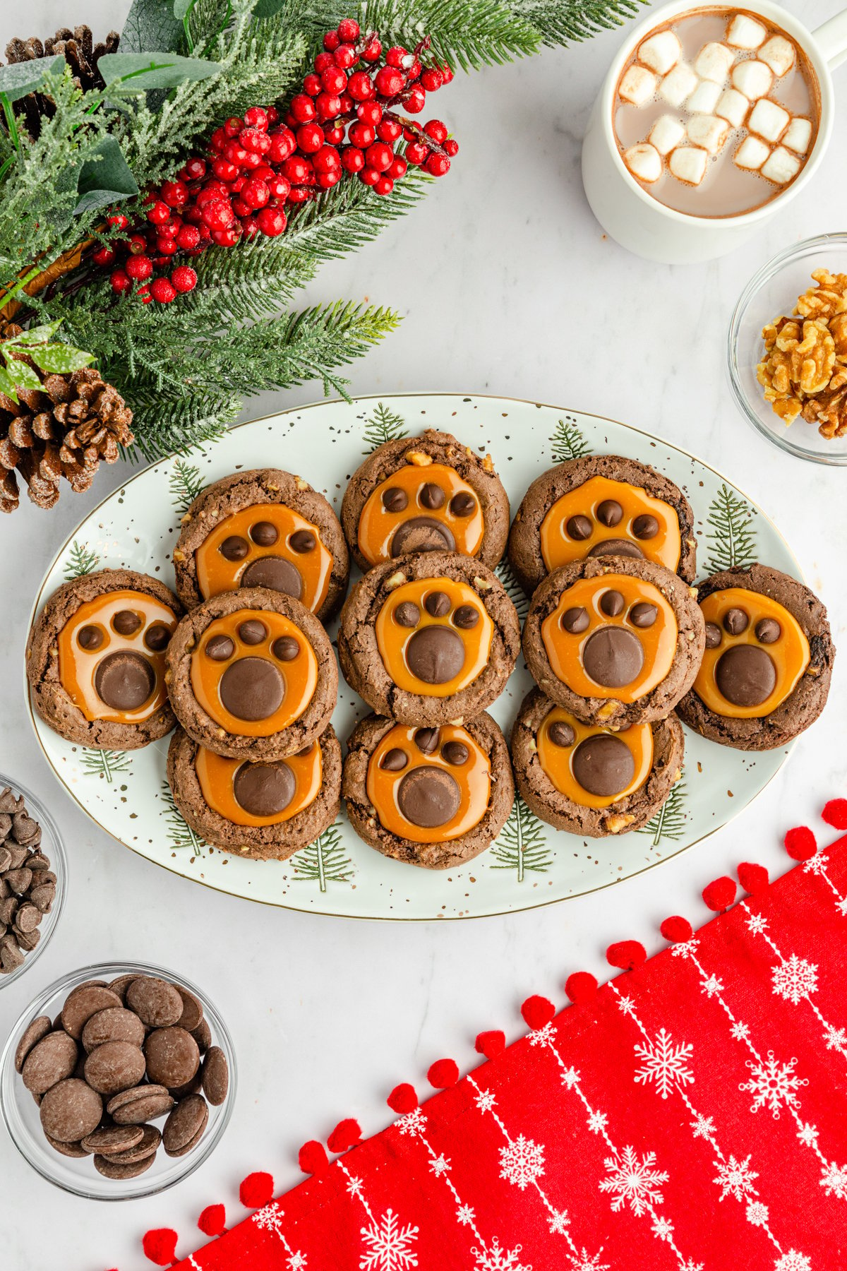 white plate with a bunch of bear paw cookies