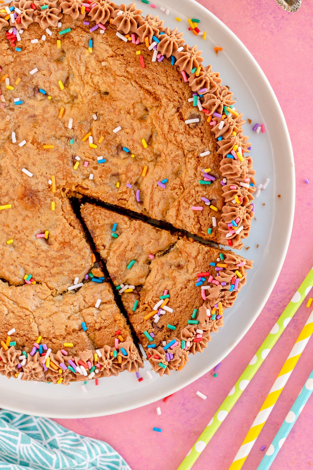 a chocolate chip cookie cake with a piece sliced out