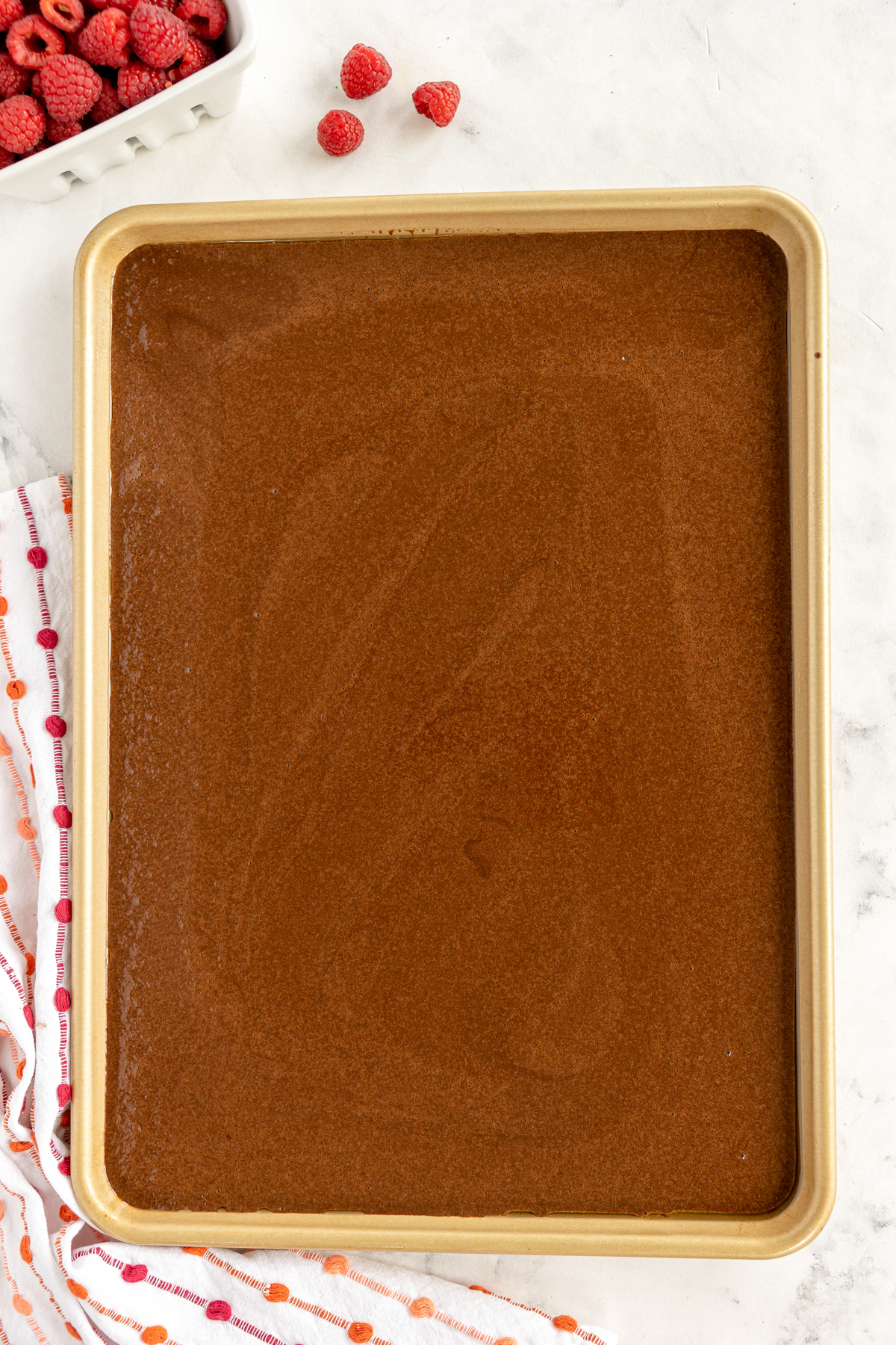 chocolate cake batter in a sheet pan