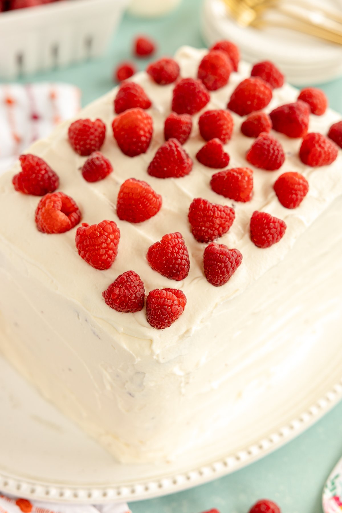 frosted chocolate raspberry cake with fresh raspberries on top