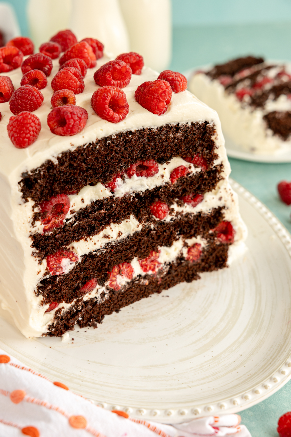 sliced chocolate raspberry cake on a white cake platter