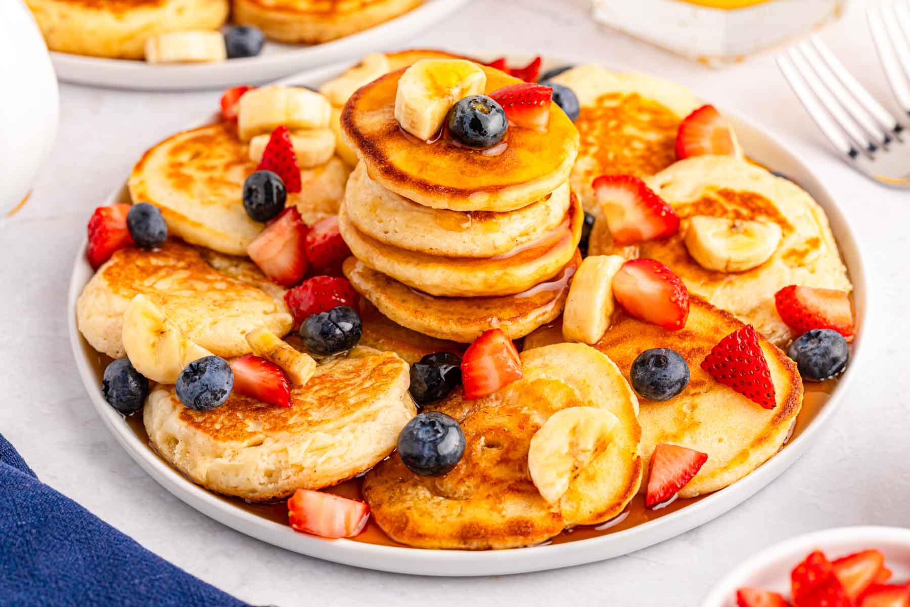 white plate with a stack of mini pancakes