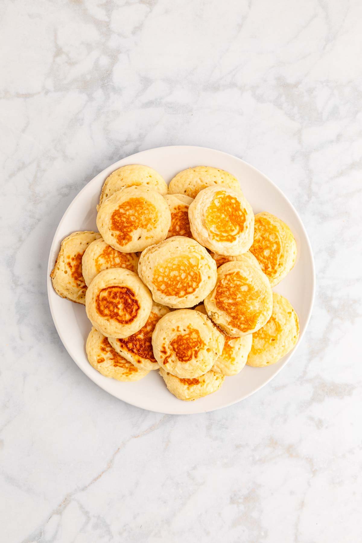 white plate full of mini pancakes