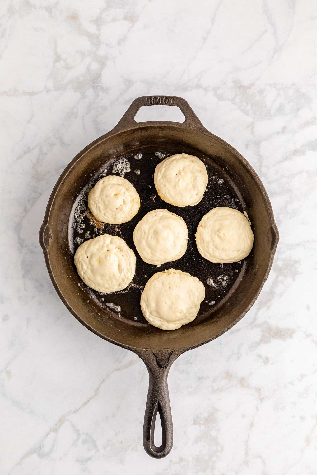 mini pancakes cooking in a skillet