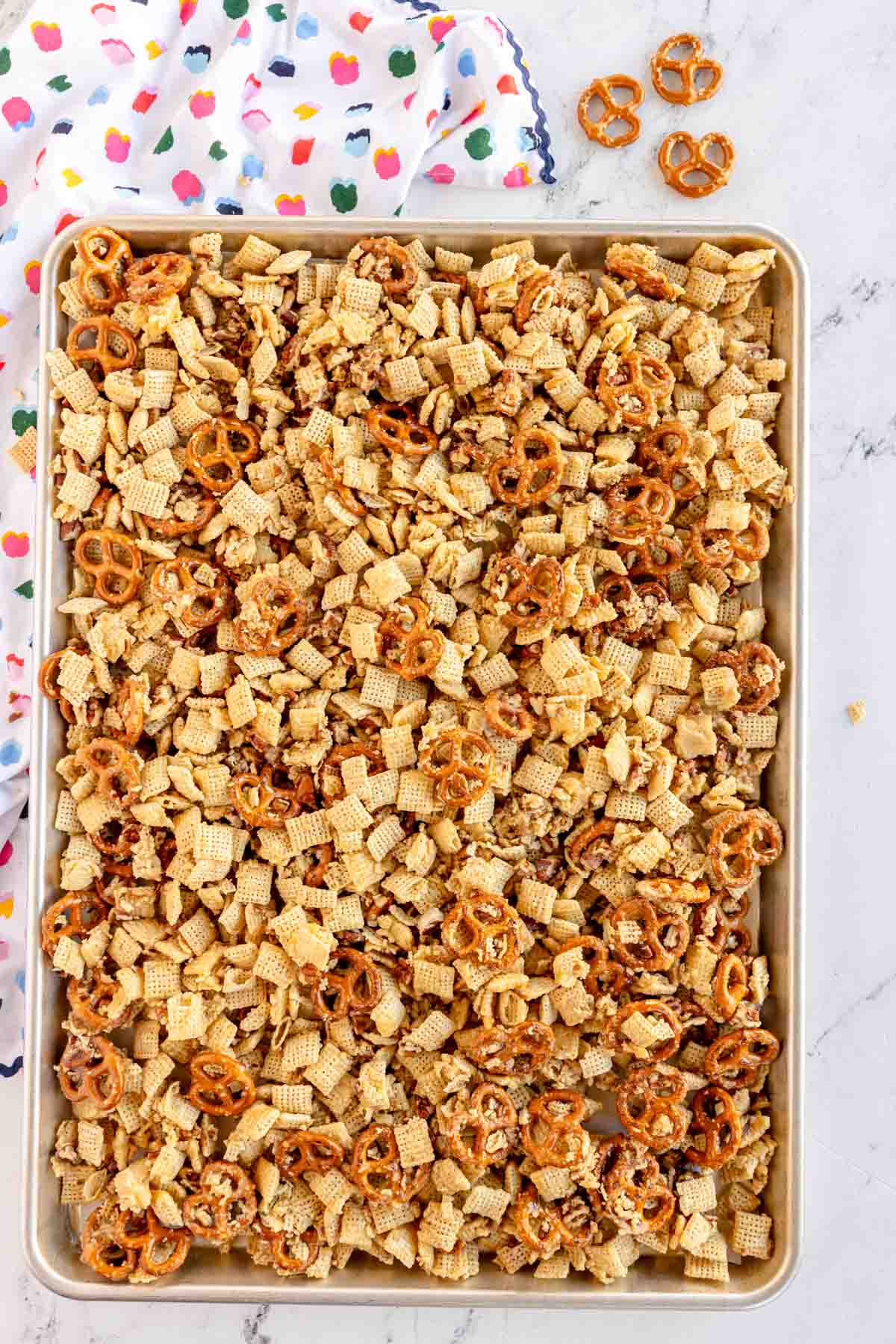 baking sheet with sweet chex mix about to be baked