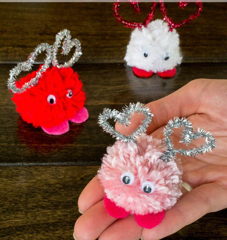 DIY pom poms with googly eyes and heart antenas