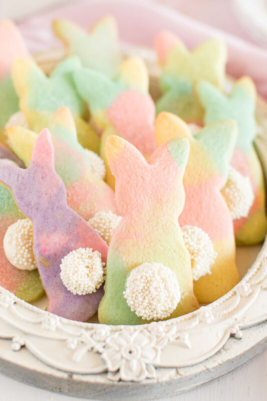 tray full of marble rainbow bunny cookies with cute sprinkle tails