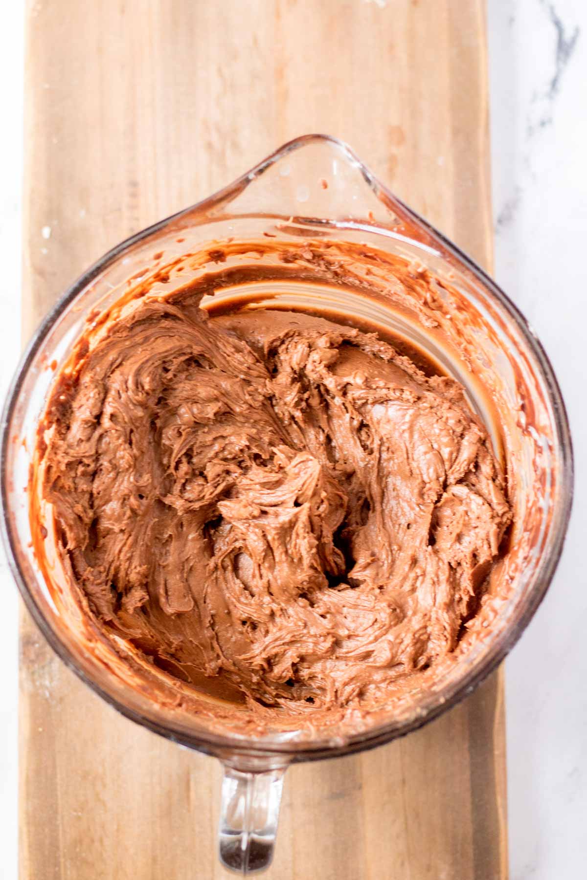 chocolate frosting in a glass bowl