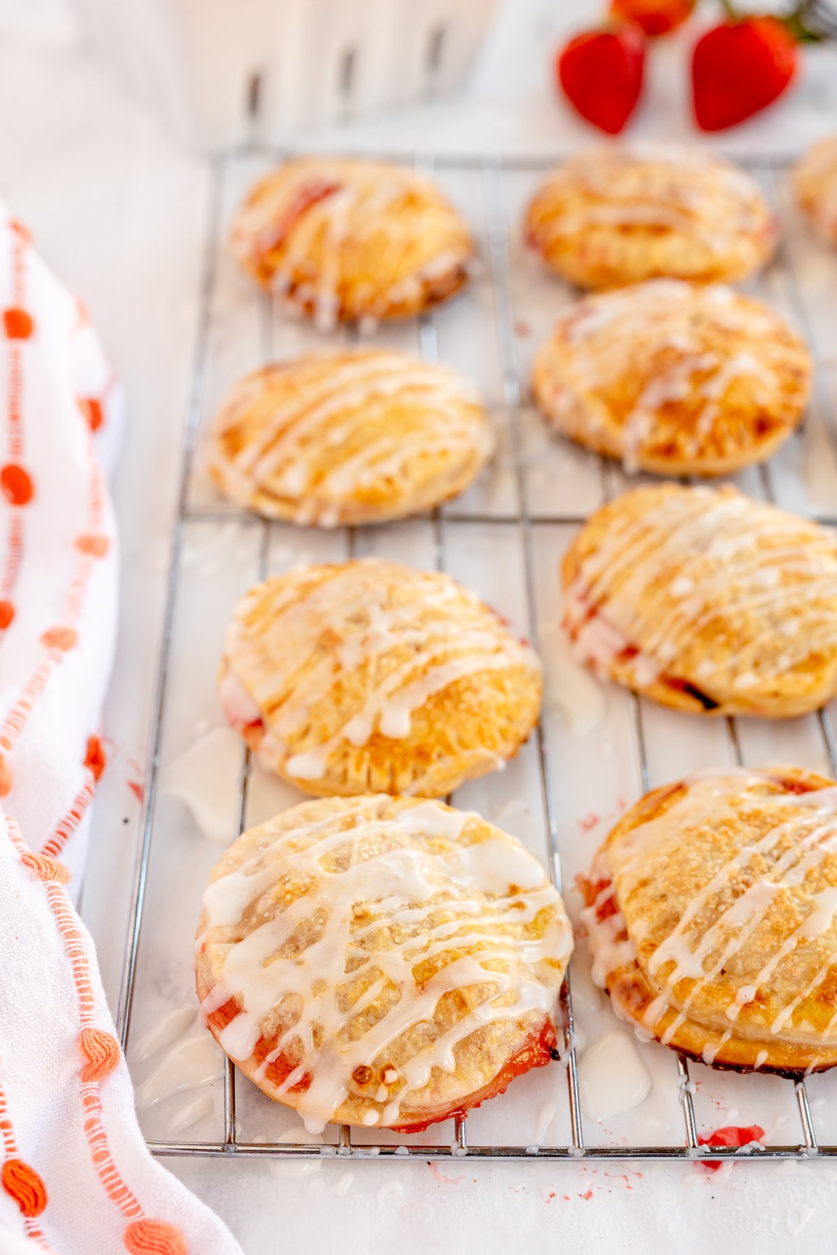 strawberry hand pies cooling on a cooling rack