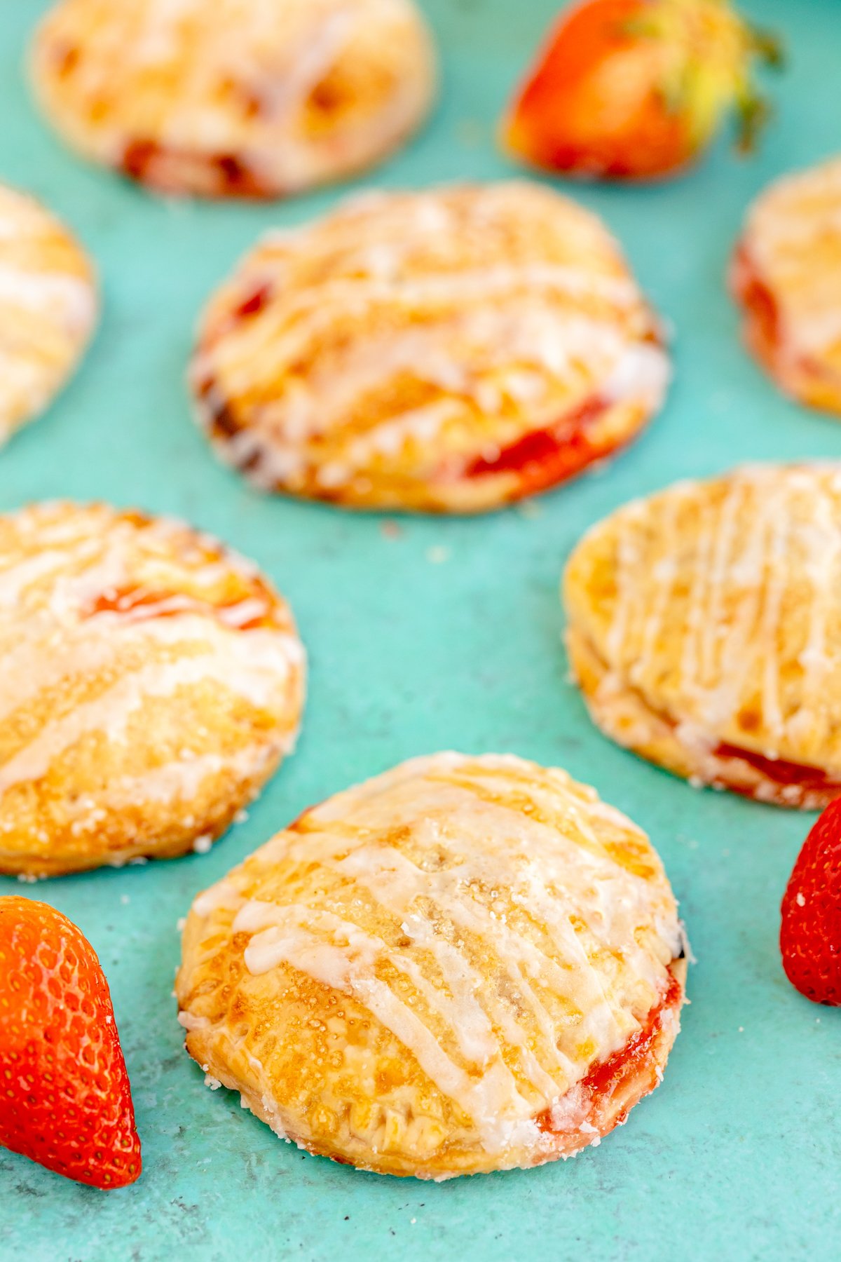 strawberry hand pies on a teal background