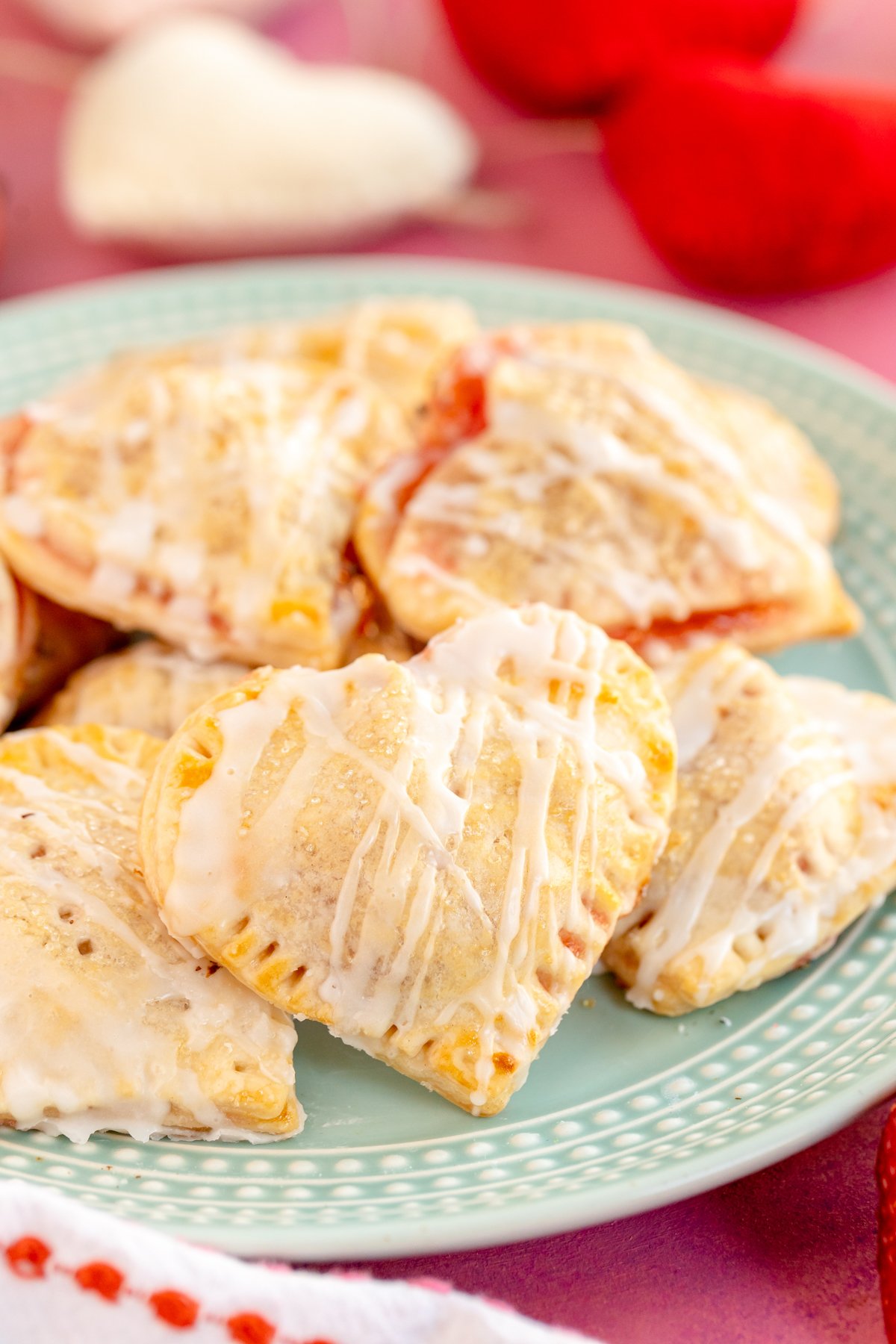 heart shaped strawberry hand pies on a plate