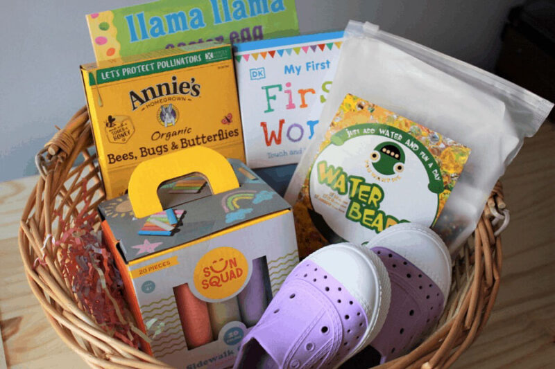 small basket with a variety of practical items such as bunny mac and cheese and chalk