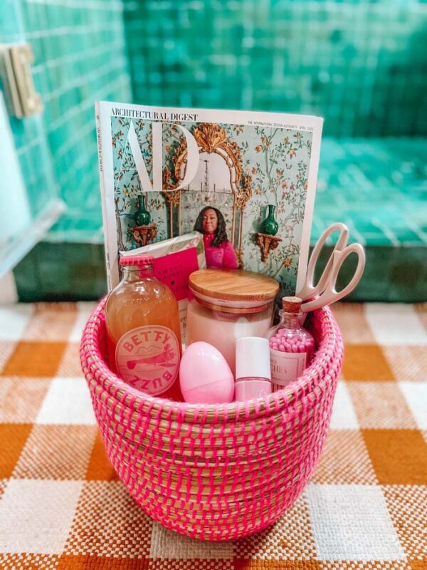 pink basket filled with a variety of everyday items