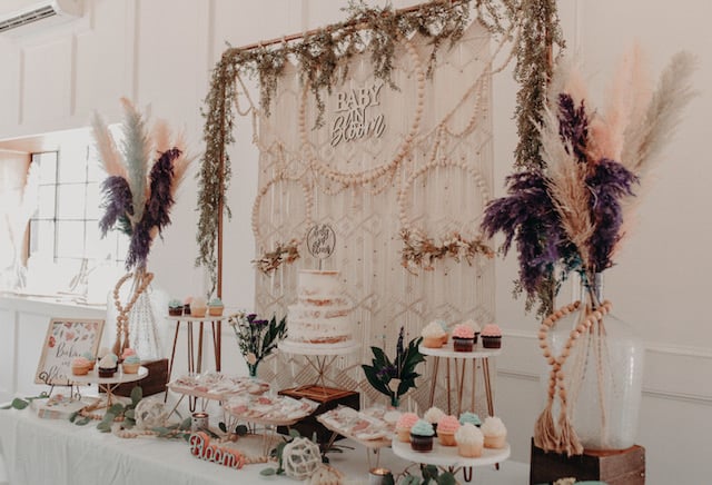 baby in bloom banner with a colorful food table under