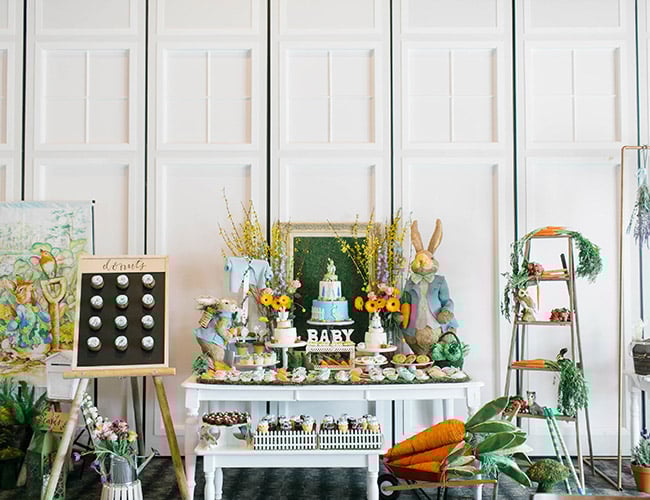 peter rabbit themes dessert table with various bunny decor items