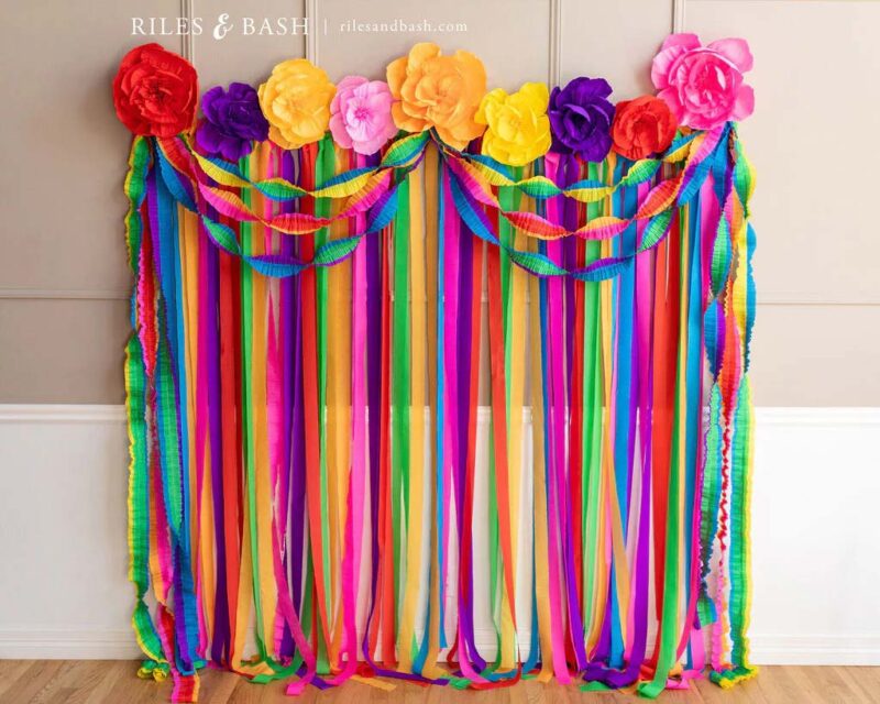 brightly colored tassels strung to create a banner with flowers.