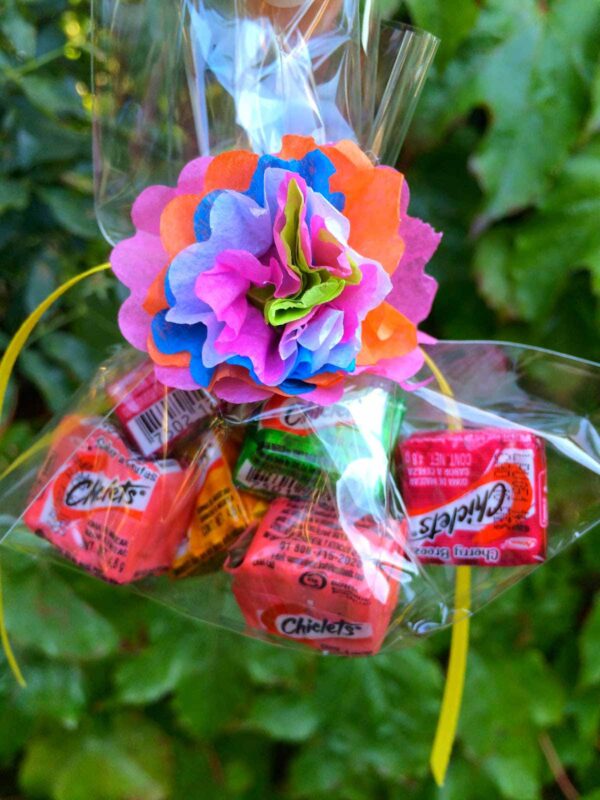 clear bag filled with candy then decorated with a DIY paper flower