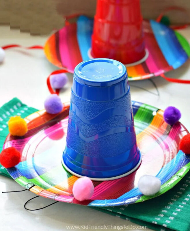 plastic cup glued onto a colorful paper plate to look like a sombrero