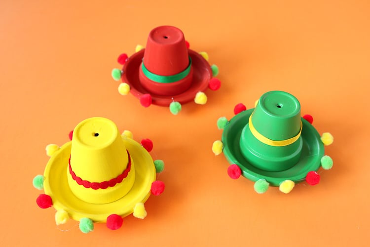 clay planters that have been painted and glued to look like a sombrero