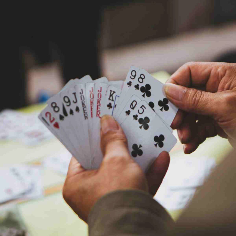hand holding a variety of playing cards