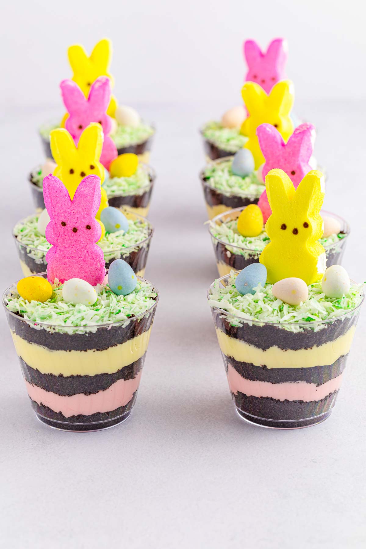 layered Easter dirt cups with pudding and Peeps on top