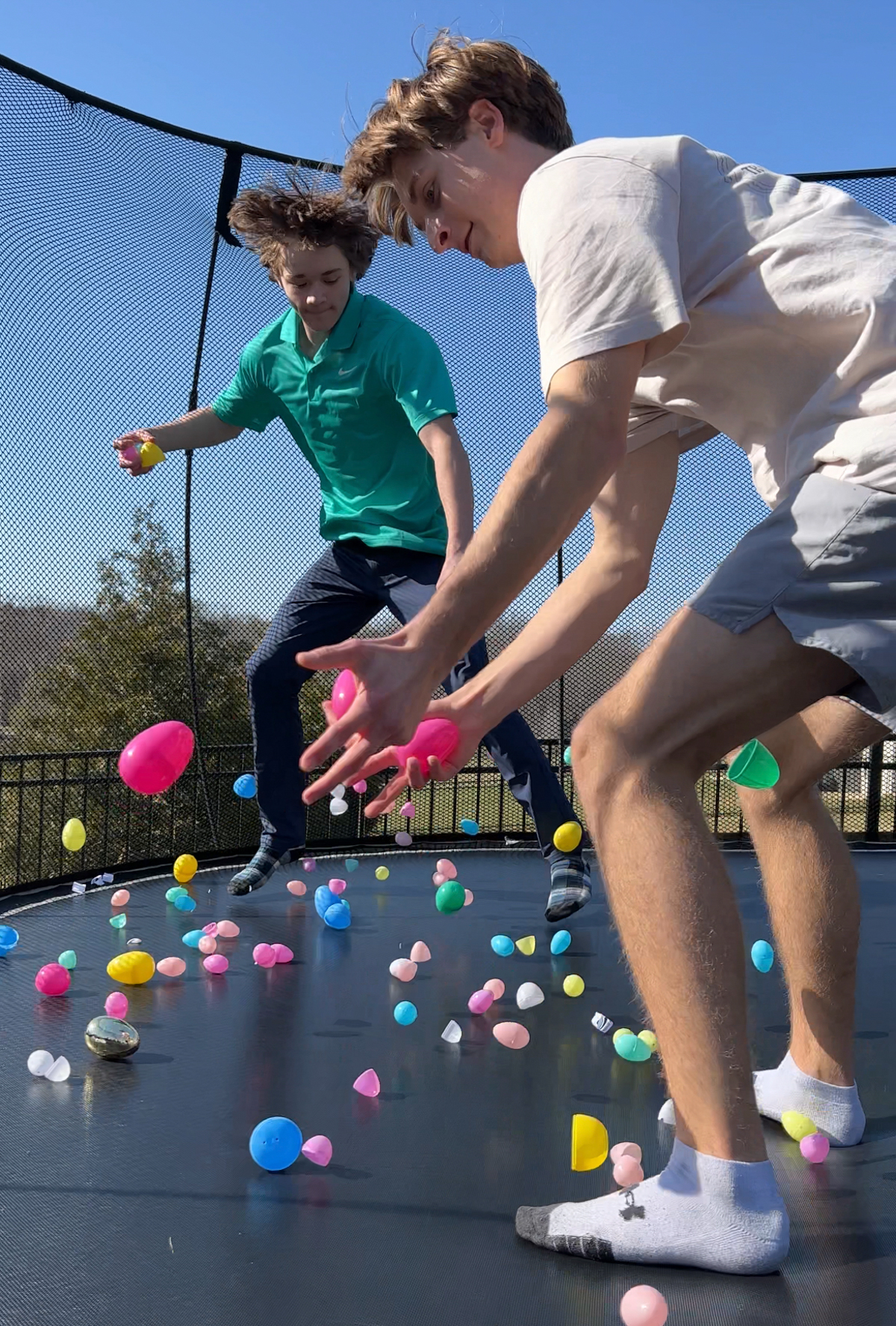 kids jumping on a trampoline with easter eggs