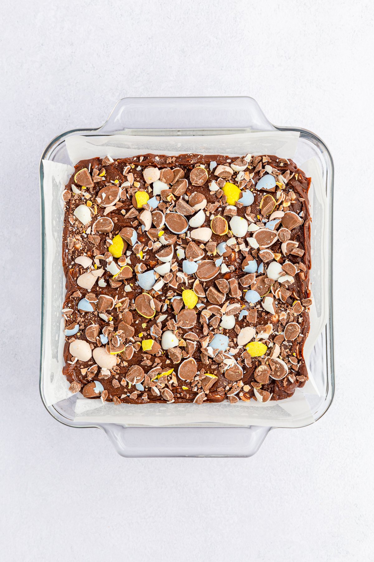 unbaked mini egg brownies in a glass pan