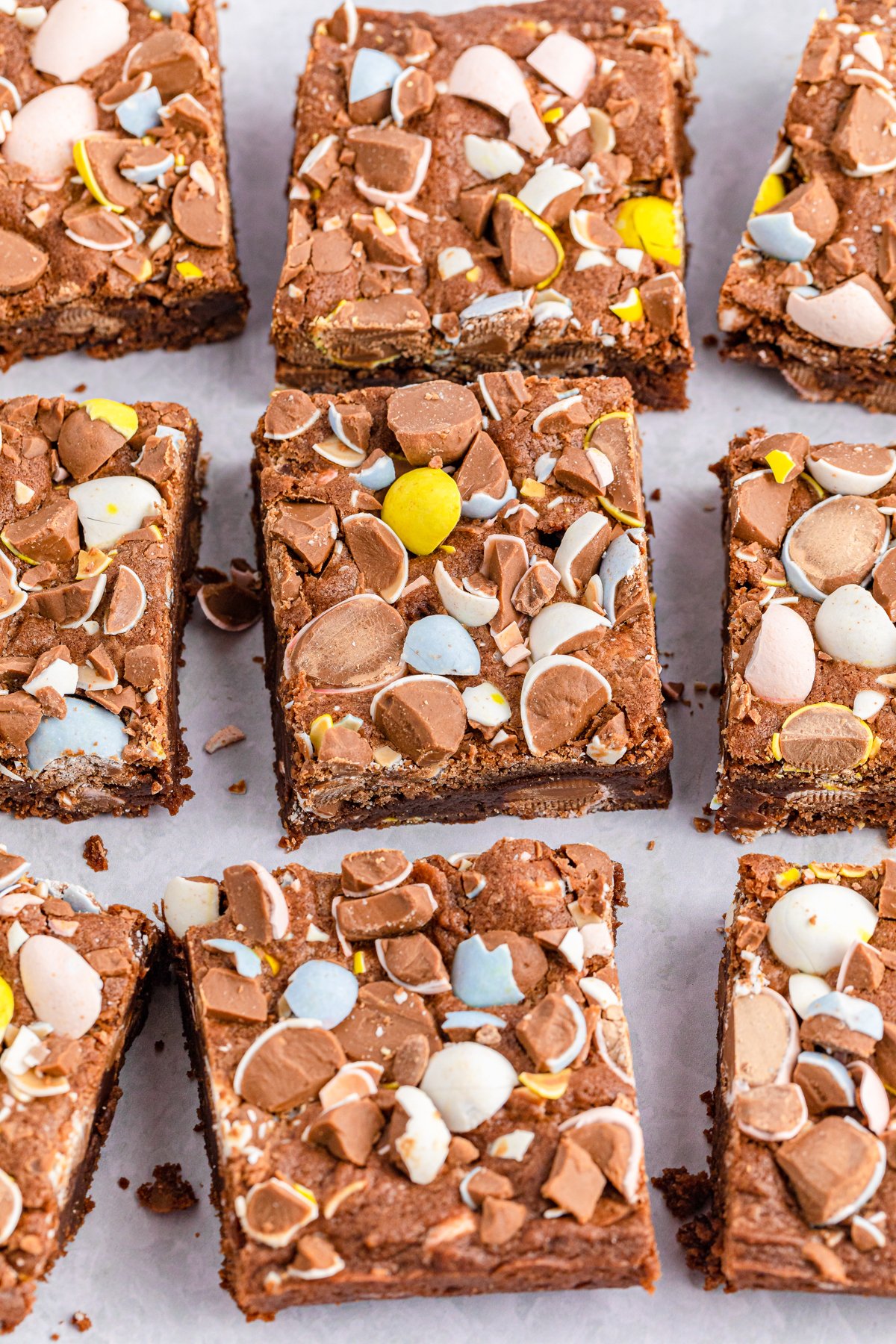cut up mini egg brownies on a piece of parchment paper