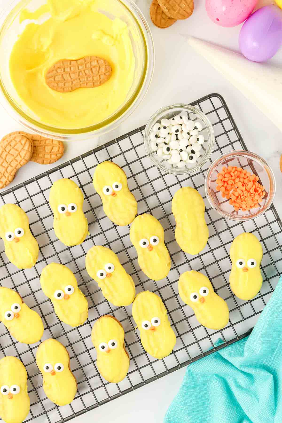 yellow coated nutter butters on a cooling rack